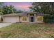 A single story home with a 2 car garage and manicured lawn at 1307 Rain Forest Ln, Minneola, FL 34715