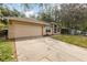 Single-Gathering home with a two car garage and long driveway at 1307 Rain Forest Ln, Minneola, FL 34715