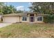 Single-Gathering home with attached garage, front lawn, and a beautiful sunset sky at 1307 Rain Forest Ln, Minneola, FL 34715