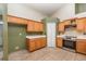 Bright kitchen features wood cabinets, white countertops, and stainless steel appliances at 1307 Rain Forest Ln, Minneola, FL 34715