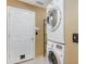 Convenient laundry area with a stacked washer and dryer unit at 1307 Rain Forest Ln, Minneola, FL 34715