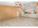 Large living room showcasing tiled floors and natural light, flowing into kitchen at 1307 Rain Forest Ln, Minneola, FL 34715