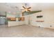 Spacious living room featuring ample lighting and easy access to the adjacent kitchen at 1307 Rain Forest Ln, Minneola, FL 34715