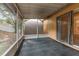 Enclosed patio with gray storage building and sliding glass door to home's interior at 1307 Rain Forest Ln, Minneola, FL 34715
