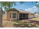 Home exterior highlighting the screened-in porch, fenced-in yard, and established landscaping at 13301 Biscayne Dr, Grand Island, FL 32735