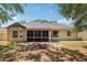 The back of the home has a screened in porch as well as a fenced-in yard and a garden at 13301 Biscayne Dr, Grand Island, FL 32735