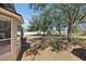 Rear exterior view of the home and surrounding yard featuring mature trees, a fence, and lush lawn at 13301 Biscayne Dr, Grand Island, FL 32735