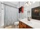 Classic bathroom featuring a vanity, a shower with curtain, and neutral tiling at 13301 Biscayne Dr, Grand Island, FL 32735