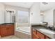 Bright bathroom with double sinks, soaking tub, and glass shower at 13301 Biscayne Dr, Grand Island, FL 32735