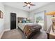 Relaxing bedroom with a queen bed, natural light, and carpeted floors at 13301 Biscayne Dr, Grand Island, FL 32735