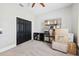 Bedroom with black closet doors, neutral paint, carpet flooring, and rack for storage at 13301 Biscayne Dr, Grand Island, FL 32735