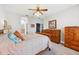 Bedroom featuring archways, furniture, and ceiling fan at 13301 Biscayne Dr, Grand Island, FL 32735
