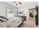 Comfortable bedroom with a bed, mounted tv, ceiling fan, and a window at 13301 Biscayne Dr, Grand Island, FL 32735
