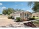 Side view of the home with concrete walkway and a well-maintained lawn at 13301 Biscayne Dr, Grand Island, FL 32735