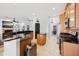 Spacious kitchen featuring wood cabinets, granite countertops, stainless steel appliances, and an island at 13301 Biscayne Dr, Grand Island, FL 32735