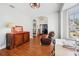 Well-lit living room showcasing hardwood floors, a decorative cabinet, and views to other rooms at 13301 Biscayne Dr, Grand Island, FL 32735