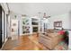 Well-lit living room featuring a decorative fireplace, built-in shelving, and hardwood floors at 13301 Biscayne Dr, Grand Island, FL 32735