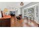 Inviting living room with hardwood floors, natural light, and comfortable seating by the window at 13301 Biscayne Dr, Grand Island, FL 32735