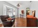 Comfortable living room featuring a bay window, hardwood floors, and a leather recliner at 13301 Biscayne Dr, Grand Island, FL 32735