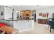 Bright open-concept space with a kitchen and dining area featuring dark granite countertops at 13301 Biscayne Dr, Grand Island, FL 32735