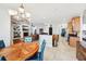 Open-concept living space with dining area, kitchen, and living room with fireplace and entertainment center at 13301 Biscayne Dr, Grand Island, FL 32735
