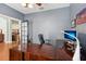 Home office with a large desk, a comfortable black chair, and plenty of natural light at 13301 Biscayne Dr, Grand Island, FL 32735
