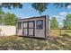 New backyard storage shed with double doors, windows, and neutral siding on a level lot at 13301 Biscayne Dr, Grand Island, FL 32735