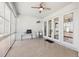 The home's screened lanai features speckled flooring, white trim, and glass sliders to the interior at 13301 Biscayne Dr, Grand Island, FL 32735