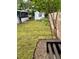 Well-kept backyard with manicured lawn, lush greenery, storage shed and screened in patio at 1414 Margate Ave, Orlando, FL 32803