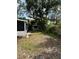 Spacious backyard with lush trees and a storage shed, offering a serene outdoor space at 1414 Margate Ave, Orlando, FL 32803