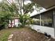 Backyard featuring a screened in porch and storage shed at 1414 Margate Ave, Orlando, FL 32803