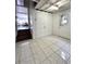 Basement entry featuring large tile flooring and a stairwell leading to a sunlit living space at 1414 Margate Ave, Orlando, FL 32803