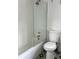Bathroom featuring a bathtub with white subway tile and glass shower door at 1414 Margate Ave, Orlando, FL 32803