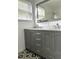 A modernized bathroom highlights a double vanity with granite countertops at 1414 Margate Ave, Orlando, FL 32803