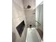 Bathroom featuring a modern tiled bathtub with a rainfall shower head and a built-in shower niche at 1414 Margate Ave, Orlando, FL 32803