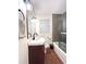 Bathroom showcasing a vanity with a dark wood base and a sink, complemented by a shower tub combo at 1414 Margate Ave, Orlando, FL 32803