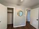 Bedroom featuring two doorways and a closet, with hardwood floors and decorative mirror accent at 1414 Margate Ave, Orlando, FL 32803