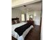 A naturally lit bedroom showcases hardwood flooring and neutral-toned bedding at 1414 Margate Ave, Orlando, FL 32803
