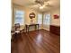 Bright bedroom featuring three windows, ceiling fan, hardwood flooring, and classic furnishings at 1414 Margate Ave, Orlando, FL 32803