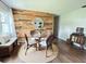 Cozy dining area with unique wood accent wall, stylish decor, and a round jute rug at 1414 Margate Ave, Orlando, FL 32803