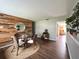 Cozy dining area with unique wood accent wall, stylish decor, and a round jute rug at 1414 Margate Ave, Orlando, FL 32803