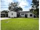 Charming single-story home with a well-manicured lawn and a covered carport to the side at 1414 Margate Ave, Orlando, FL 32803