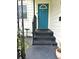 Inviting entrance featuring a vibrant blue front door with steps leading up to the home at 1414 Margate Ave, Orlando, FL 32803