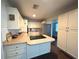 A well-lit kitchen showcases white cabinets, updated countertops, and stainless steel appliances at 1414 Margate Ave, Orlando, FL 32803