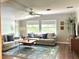 Bright living room with comfortable seating, a ceiling fan, and natural light at 1414 Margate Ave, Orlando, FL 32803