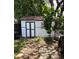 Well-maintained backyard shed with stylish trim, adjacent to a charming, tree-lined yard at 1414 Margate Ave, Orlando, FL 32803