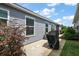 Back patio with a barbecue grill and manicured yard at 1486 Joshua Ct, The Villages, FL 32163