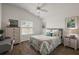 Bedroom with ceiling fan, luxury vinyl plank flooring, and side table with lamp at 1486 Joshua Ct, The Villages, FL 32163