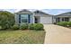 Charming home with well-maintained landscaping, a two-car garage, and a welcoming front entrance at 1486 Joshua Ct, The Villages, FL 32163