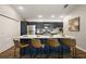 Modern kitchen island with barstool seating, stainless steel appliances, and sleek countertops at 1486 Joshua Ct, The Villages, FL 32163